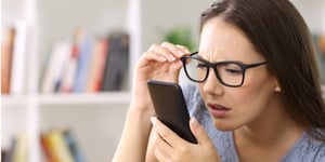 girl-with-eyesight-problems-trying-to-read-phone-text-picture-id865753800